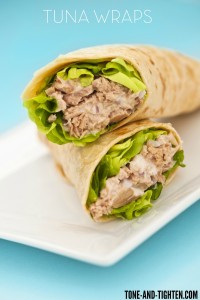 Two tuna melt wrap on a white plate on a blue background
